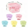 A collage of small, colorful, square plastic food storage containers with lids, with dimensions indicated for the largest pink container. Produktbild-Vorschau