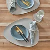 A table setting with two place settings, each featuring a placemat, plate, cutlery, and a folded napkin with a small floral accent. Anteprima dell’immagine prodotto