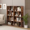 A wooden bookshelf filled with books and decorative items in a living room setting. Podgląd zdjęcia produktu