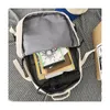 The inside of an open backpack is shown, with books and a folded umbrella inside. Náhľad obrázku produktu
