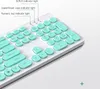 A close-up view of a white and mint green keyboard with round keys. Náhled obrázku produktu