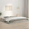 A minimalist bedroom scene with a wooden bed frame and bedding. Náhled obrázku produktu