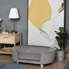 A pet sofa is placed in a room with a nightstand, lamp, and abstract art. Produktbild-Vorschau