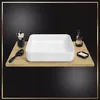 A white rectangular sink is placed on a wooden shelf, with bathroom accessories like toothbrushes, a soap dispenser, and a soap dish. Náhľad obrázku produktu