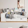 A white daybed with a bookshelf and desk unit attached, set up in a room with a rug and artwork on the wall. Produktbild-Vorschau
