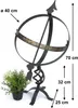 A sundial on a stand, with a potted plant next to it. Dimensions are indicated with arrows and text. Anteprima dell’immagine prodotto
