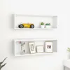 Two white cube shelves mounted on a white wall, each displaying decorative items. Náhľad obrázku produktu