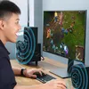 A person playing a video game on a computer with speakers. Náhled obrázku produktu