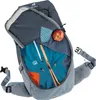 An open backpack with clothing and an apple inside. Podgląd zdjęcia produktu
