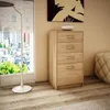 A chest of drawers in a room with a large window and a floor lamp. Produktbild-Vorschau