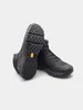 A pair of black hiking boots shown from a low angle, with one boot on its side revealing the sole. Anteprima dell’immagine prodotto