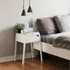 A bedroom scene with a bedside table and bed. Anteprima dell’immagine prodotto