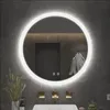 A modern bathroom with a round LED mirror, sink, and faucets. Voir les images du produit