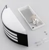 A disassembled wall light fixture with its mounting base and screws on a light gray background. Anteprima dell’immagine prodotto