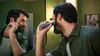 A man is trimming his beard in front of a mirror. Voir les images du produit