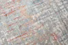 A close-up, angled view of a textured rug with a distressed pattern. Anteprima dell’immagine prodotto