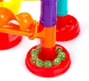 A close-up shot of a colorful marble run toy with marbles at the base. Produktbild-Vorschau