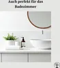 A clean and modern bathroom vanity with a sink, faucet, soap dispenser, folded towel, and a potted plant. Anteprima dell’immagine prodotto