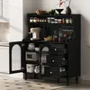 A black kitchen cabinet with glass doors and drawers, filled with kitchenware and appliances. Podgląd zdjęcia produktu
