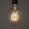 A close-up shot of a vintage-style LED light bulb with a decorative filament. Produktbild-Vorschau