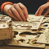 Hands assembling a wooden 3D puzzle. Náhľad obrázku produktu