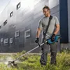 A man is using a cordless string trimmer to cut grass in front of a modern building. Voir les images du produit