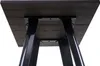 Underside view of a table with dark wood top and black metal legs. Voir les images du produit