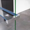 A shower shelf mounted on a glass partition, with a dark wooden door and tiled floor in the background. Produktbild-Vorschau