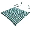 A green and white checkered seat cushion with ties. Produktbild-Vorschau