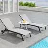 Two lounge chairs and a small table on a patio next to a pool. Podgląd zdjęcia produktu