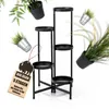 A black metal plant stand with multiple tiers, surrounded by floating potted plants and a wooden tag. Produktbild-Vorschau