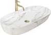 A white oval countertop sink with gold veining and a gold faucet. Náhľad obrázku produktu