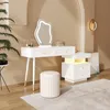 A modern white vanity set with a lighted mirror, stool, and nightstand in a softly lit room. Voir les images du produit