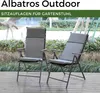 Two grey outdoor chairs with cushions are placed on a wooden deck, surrounded by greenery. Produktbild-Vorschau