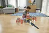 A young boy is playing with a toy train set on the floor in a living room. Náhľad obrázku produktu