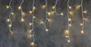 Icicle lights hanging against a dark textured background. Náhled obrázku produktu