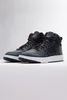 A pair of dark blue Adidas Hoops 3.0 Mid WTR sneakers with brown laces are displayed on a white surface against a light gray background. Anteprima dell’immagine prodotto
