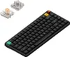 A black Nuphy Air75 V3 wireless mechanical keyboard is shown from a diagonal angle. Two keyboard switches are placed to the left of the keyboard. Produktbild-Vorschau