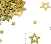 A pile of gold star-shaped confetti scattered on a white background, with a ruler indicating the size of one star. Produktbild-Vorschau