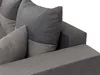 A close-up view of a sectional sofa's corner and cushions. Náhled obrázku produktu