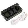 A black programmable keyboard with a silver knob and a white USB cable on a white background. Náhľad obrázku produktu