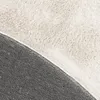 A close-up view of the texture of a rug, showing the fluffy top layer and the woven backing. Produktbild-Vorschau