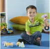 A young boy is sitting on a blue mat, playing with colorful foam toys and toy vehicles. He is holding a purple foam toy in his hand and smiling. Produktbild-Vorschau
