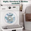 A washing machine with a laundry basket and towels. Produktbild-Vorschau