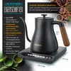 A black electric kettle with a wooden handle sits on its base, with text and graphics detailing its features. The background includes decorative elements like tea leaves and bowls. Náhled obrázku produktu