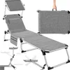A grey foldable sun lounger is shown in various configurations, including a folded state being held by a hand, and with additional diagrams showing accessories. Náhled obrázku produktu