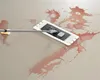 A mop cleaning a red spill on a floor. Produktbild-Vorschau