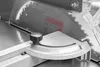 A close-up view of a miter saw's angle gauge and blade guard. Anteprima dell’immagine prodotto