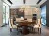 A dining room setting with a round table, chairs, and kitchen cabinets in the background. Anteprima dell’immagine prodotto