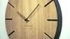 A close-up shot of a wooden wall clock with black hour markers and hands. Náhled obrázku produktu
